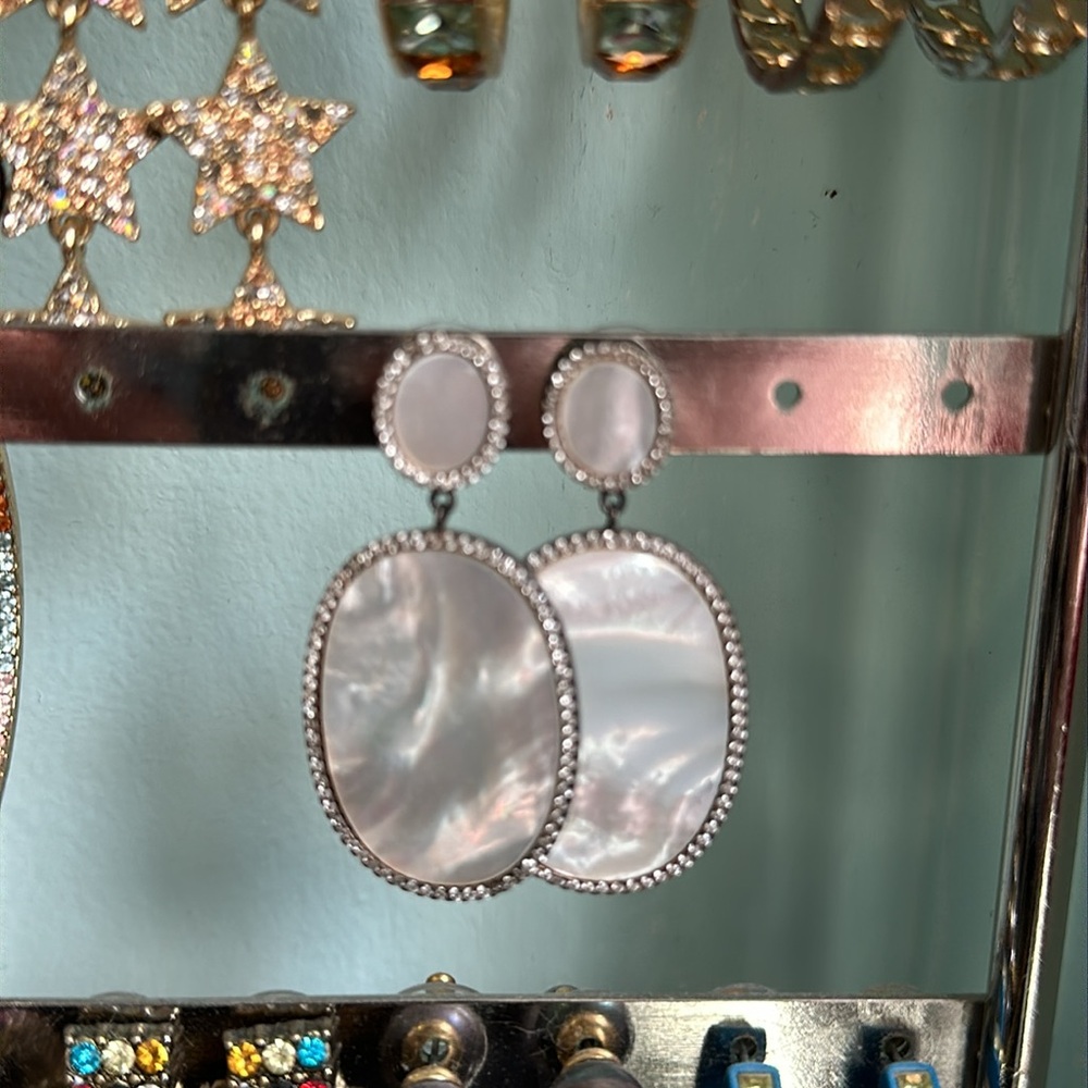 Mother of pearl oval hanging earrings.